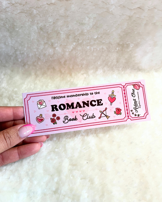 Sticker with 'Lifetime membership to the Romance Book Club' text held by a hand on a textured white background